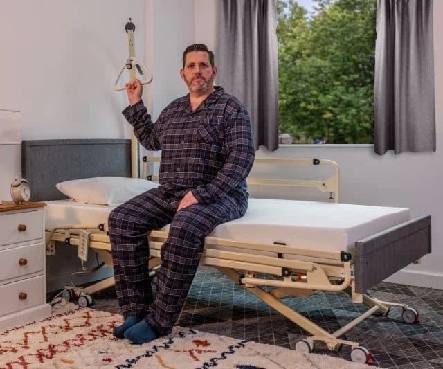 Disabled man on a Laybrook care bed